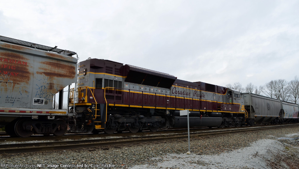 Heritage unit, CP 7013, mid-train DPU on a unit, empty grain hopper train